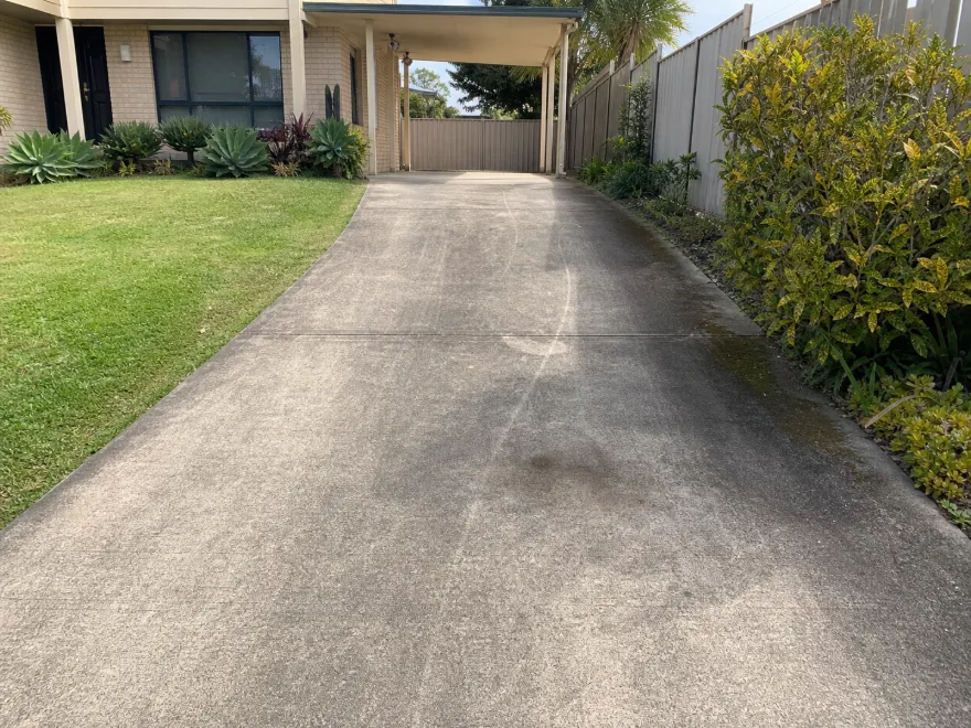 Stained concrete driveway before pressure washing
