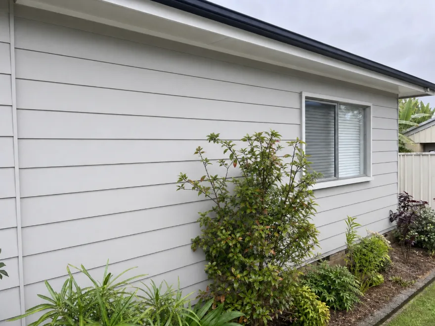Freshly soft-washed house exterior wall, bright and clean