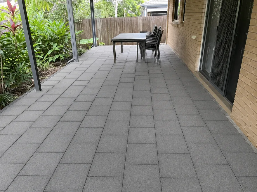 Covered Brisbane patio with clean charcoal pavers after pressure washing